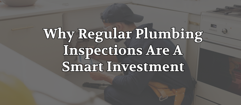 Professional plumber inspecting plumbing beneath a kitchen sink during a routine home maintenance visit.